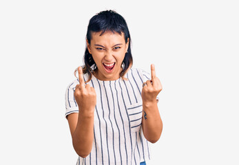 Young woman wearing casual clothes showing middle finger doing fuck you bad expression, provocation...