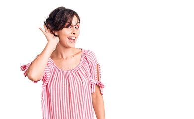 Fototapeta premium Beautiful young woman with short hair wearing casual summer clothes smiling with hand over ear listening an hearing to rumor or gossip. deafness concept.