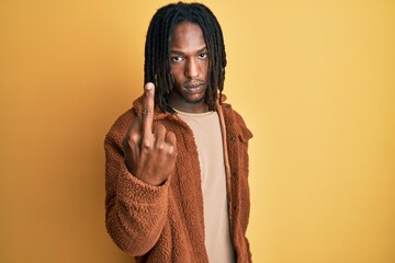 African american man with braids wearing brown retro jacket showing middle finger, impolite and...