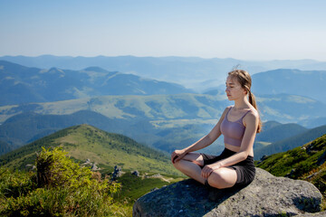 Fototapeta na wymiar Yoga, Meditation. Woman balanced, practicing meditation and zen energy yoga in mountains. Girl doing fitness exercise sport outdoors in morning. Healthy lifestyle concept.