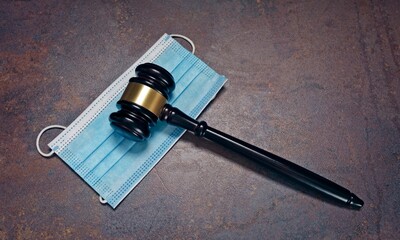 Gavel Resting On A Protective Mask on grunge background. Panoramic image with copyspace.
