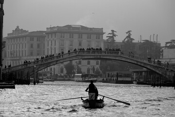 Venice, Italy, December 28, 2018 evocative black and white image of gondolas moving in a canal