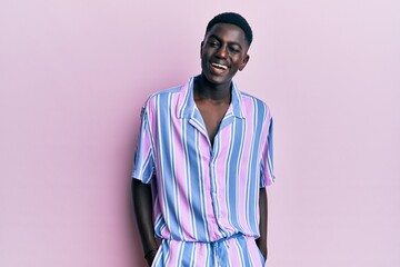 Young african american man wearing casual clothes winking looking at the camera with sexy expression, cheerful and happy face.