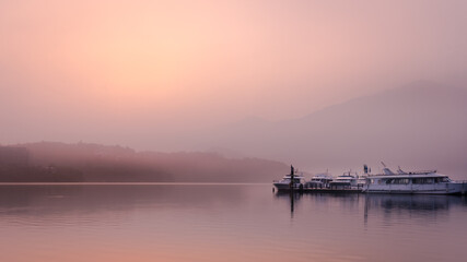 Beautiful sun rise scene of boats at pier at Sun Moon Lake, Taiwan.
