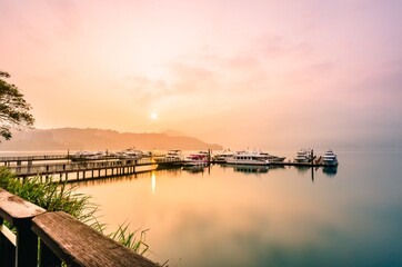 Beautiful sun rise scene of boats at pier at Sun Moon Lake, Taiw