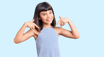 Young little girl with bang wearing casual clothes looking confident with smile on face, pointing oneself with fingers proud and happy.