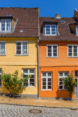 Fototapeta na wymiar Orange and yellow house in historic city Flensburg, Germany