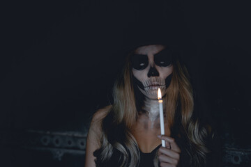 Fototapeta premium Portrait of woman make up ghost face,Mexico City’s Day of the Dead parade on Sunday honored those killed in two recent earthquakes,Thailand people,Light a candle to commemorate the people away.