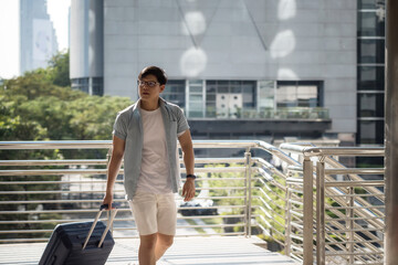 Korean solo tourist man walking with suitcase