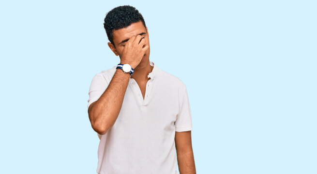 Young arab man wearing casual clothes tired rubbing nose and eyes feeling fatigue and headache. stress and frustration concept.