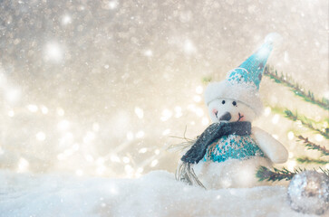 Happy toy snowman standing in winter christmas background