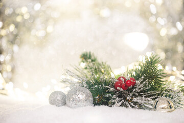 Christmas decoration with fir branch and balls on snow