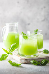 Cold basil lemonade refreshing summer drink on gray background