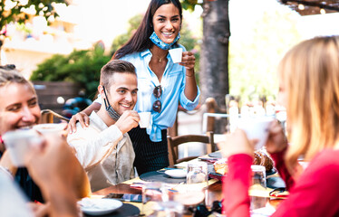 Friends drinking espresso at coffee house outdoor - Young millenial having fun together at morning restaurant - New normal lifestyle concept with happy guys and girls at cafe bar - Bright vivid filter
