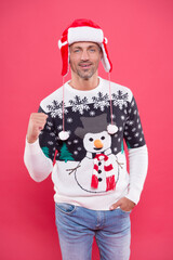 happy handsome guy in warm knitted sweater and hat celebrate winter holiday of chistmas and feel merry about xmas gifts, party fun