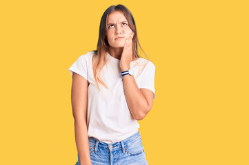 Beautiful caucasian woman wearing casual white tshirt touching mouth with hand with painful expression because of toothache or dental illness on teeth. dentist