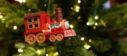 red toy locomotive hanging on the Christmas tree