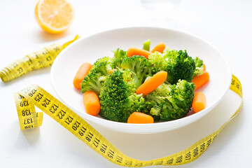 A plate of diet food, boiled vegetables, broccoli and carrots, fitness nutrition