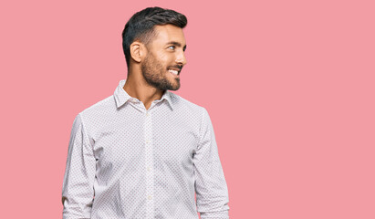 Obraz premium Handsome hispanic man wearing business clothes looking away to side with smile on face, natural expression. laughing confident.