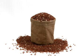 Brown rice, brown rice is placed in a brown bag and a grain of rice is placed around the bag, on a white background.