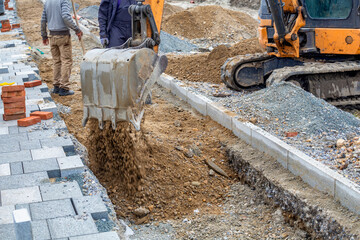 Workers backfilling power cables trenches