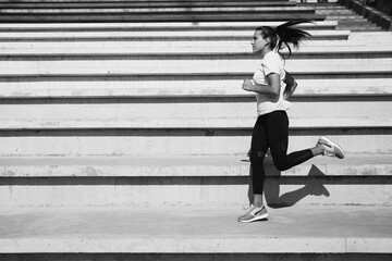 Strong fitness woman doing morning run on fresh air