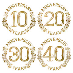 Set of golden anniversary emblems. Tenth, twentieth, thirtieth, fortieth years signs in vintage style.