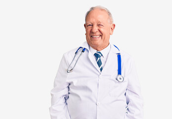 Senior handsome grey-haired man wearing doctor coat and stethoscope winking looking at the camera...
