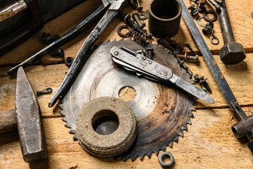 Variety of old vintage household hand tools still life on a wooden background in a DIY and repair concept