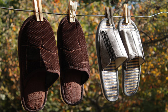 Two Pairs Of  Slippers On A Hanging Rope