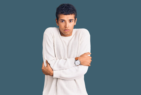 Young african amercian man wearing casual clothes shaking and freezing for winter cold with sad and shock expression on face