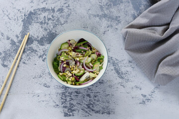 top view of a salad plate of fresh green cucumbers, celery, lettuce, red purple onions, raw buckwheat sprouts, sprouted mung bean vegan food concept Salad with vegetables and greens