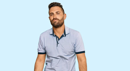 Fototapeta premium Handsome man with beard wearing casual clothes looking sleepy and tired, exhausted for fatigue and hangover, lazy eyes in the morning.