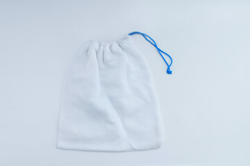 White cotton  a storage bag with ties. White background.