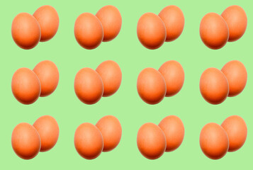 Food pattern of a pair of whole eggs on a green background.