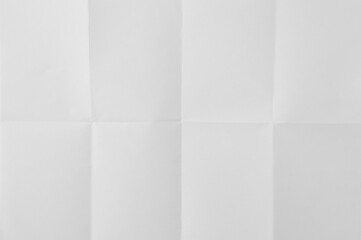 Blank paper sheet with folds vertical and horizontal. White background.