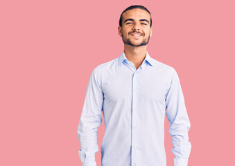 Young handsome man wearing business clothes with a happy and cool smile on face. lucky person.