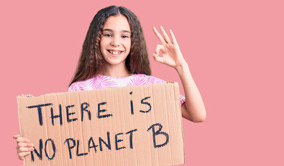 Cute hispanic child girl holding there is no planet b banner doing ok sign with fingers, smiling...
