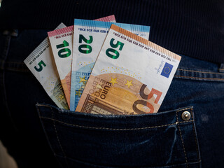 Close up of a trouser pocket with european money