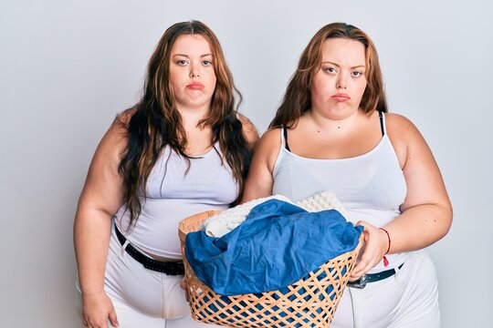 Plus size caucasian sisters woman holding laundry basket depressed and worry for distress, crying angry and afraid. sad expression.