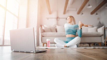 Naklejka premium Fitness woman blogger recording video on camera, training home in living room. Concept Lifestyle influencer sport and recreation