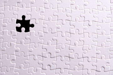 White puzzle and one missing puzzle piece