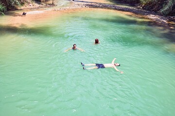 Family swimming at the river