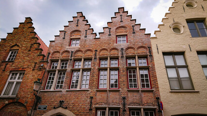 Bruges, Belgium - May 12, 2018: Roofs And Windows Of Old Authentic Brick Houses On Street Grauwwerkersstraat