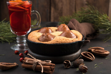 Pear pie on a brown background. Holiday background, side view. The concept of new year and Christmas.