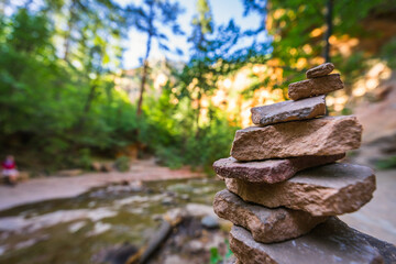 A stack of stones sits alongside the water on the Oak Tree Trail in Sedona Arizona.