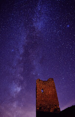 a castle with the milky way in the background