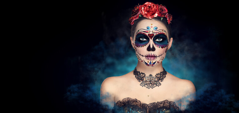 Sugar skull makeup. Halloween party, traditional Mexican carnival, Santa Muerte. Beautiful young woman costume, painted face.