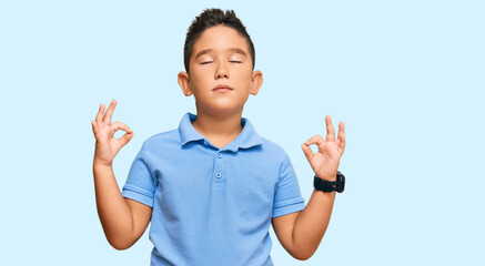 Little boy hispanic kid wearing casual clothes relaxed and smiling with eyes closed doing meditation gesture with fingers. yoga concept.