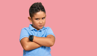 Little boy hispanic kid wearing casual clothes skeptic and nervous, disapproving expression on face with crossed arms. negative person.